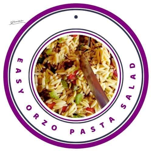 an image of a bowl of Orzo Pasta Salad with a wooden salad spoon