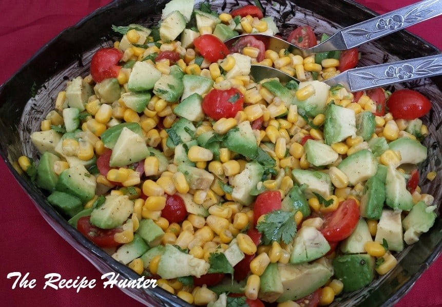 Delicious side dish or afternoon meal of Grilled corn avocado tomato salad with lime