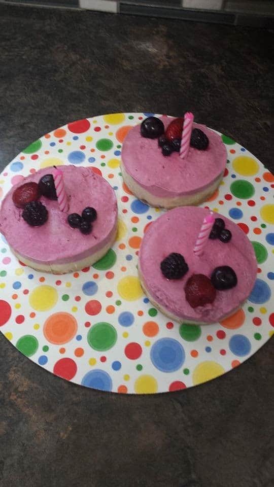 Raw Vegan Raspberry Cheesecake with berries as decoration and a birthday candle