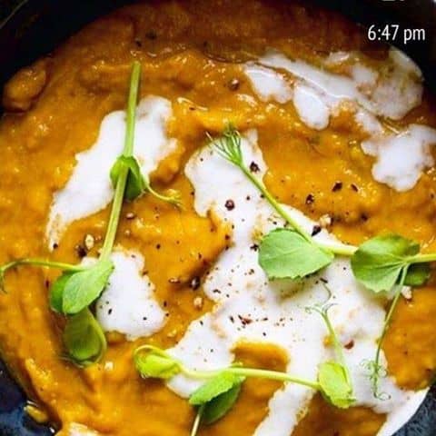 Sweet Potato Ginger Soup with cream and greens