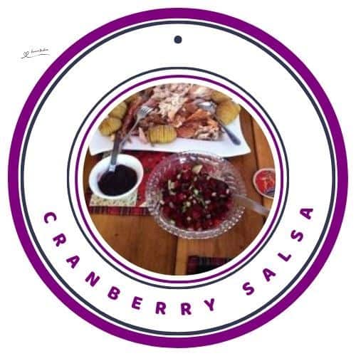an image of a bowl with Cranberry Salsa served with meat and potato dish