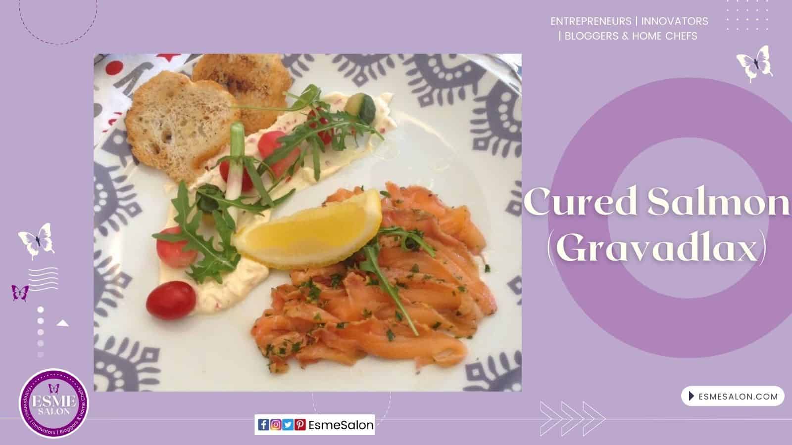 an image of Cured Salmon (Gravadlax) on a white plate with greens and tomato and some bread