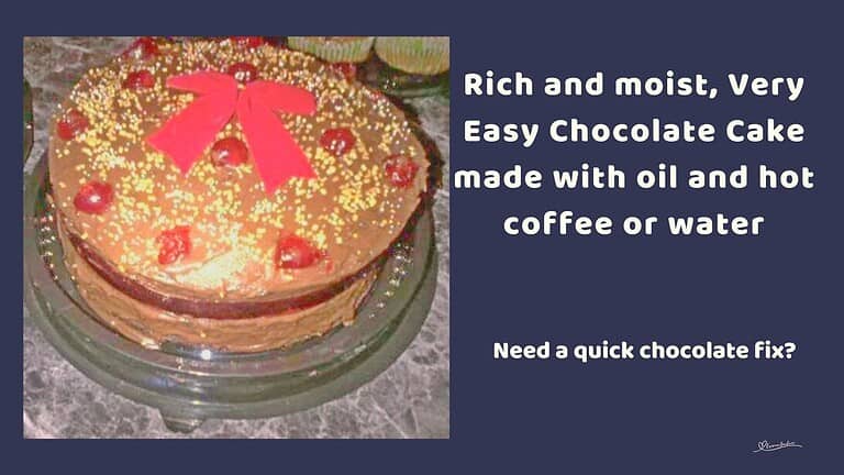 an image of a Very Easy Chocolate Cake decorated with chocolate icing, cherries and a red bow