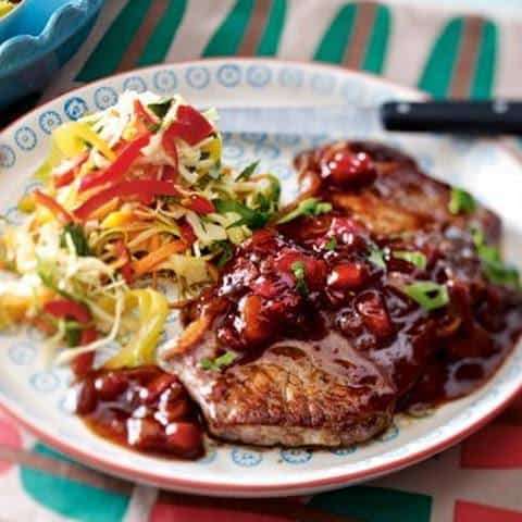 an image of a white plate with BBQ steak with Monkey Gland Sauce ad a side of potatoes