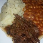 A plate of Beef Pot Roast, mash and baked beans
