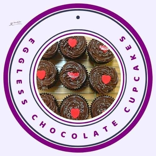 an image of Eggless Chocolate Cupcakes with sprinkles and red decorations