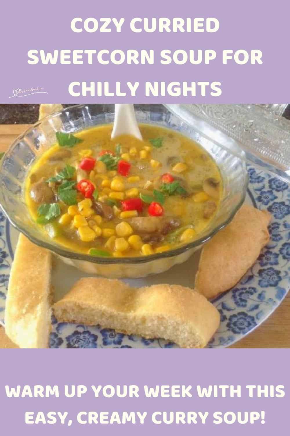 an image of a glass bowl with Curried Sweetcorn Soup and bread on the side