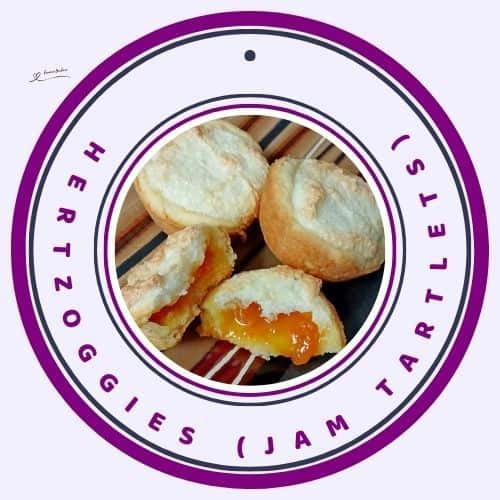 an image of Hertzoggies (Jam tartlets); jam filled and topped with a coconut fluffy mixture