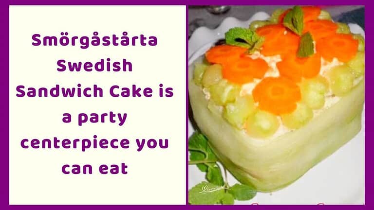 an image of a Smörgåstårta Swedish Sandwich Cake decorated with cucumber ribbons, cucumber balls, and carrot flowers