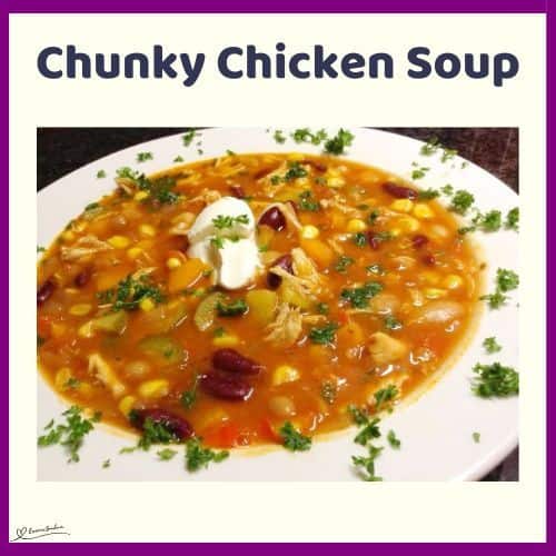 an image of a white bowl of Chunky Chicken Soup sprinkled with parsley