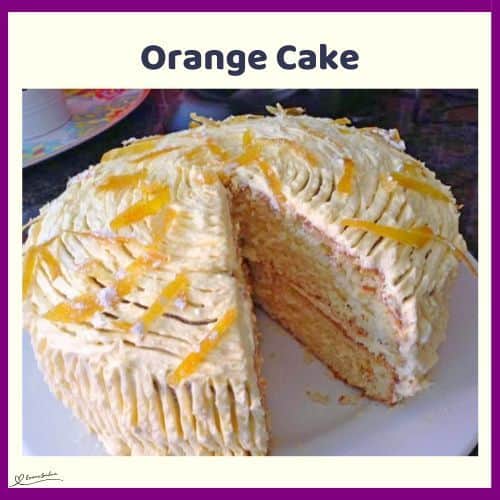 an image of a white Orange Cake with white frosting and orange zest topping