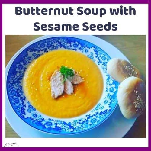 an image of a soup bowl with Butternut Soup with Sesame Seeds and bread on the side
