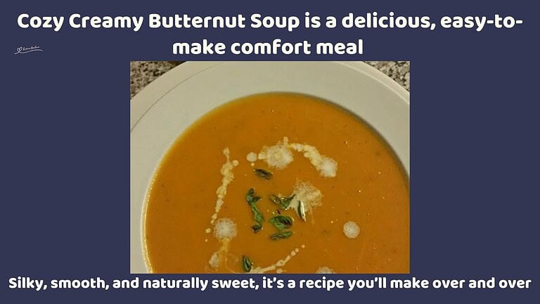 an image of a Cozy Creamy Butternut Soup in a white soup bowl with a drizzle or cream and greens