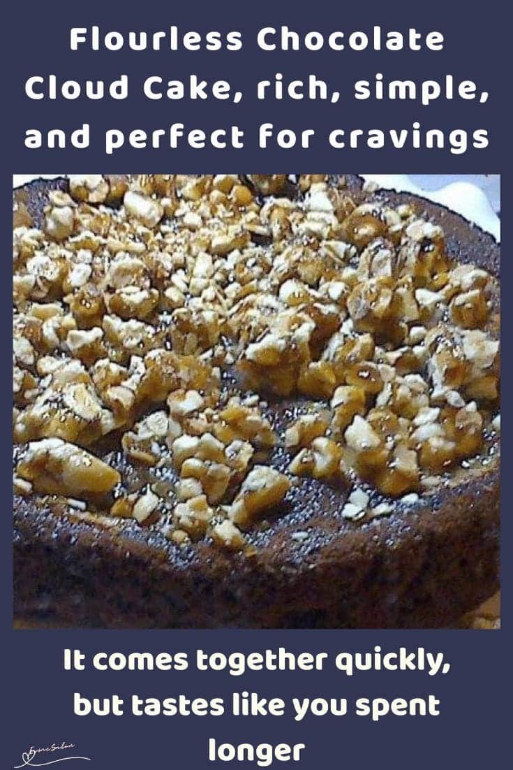 an image of a Flourless Chocolate Cloud Cake with popcorn mixed with peanut butter and chopped almonds topping