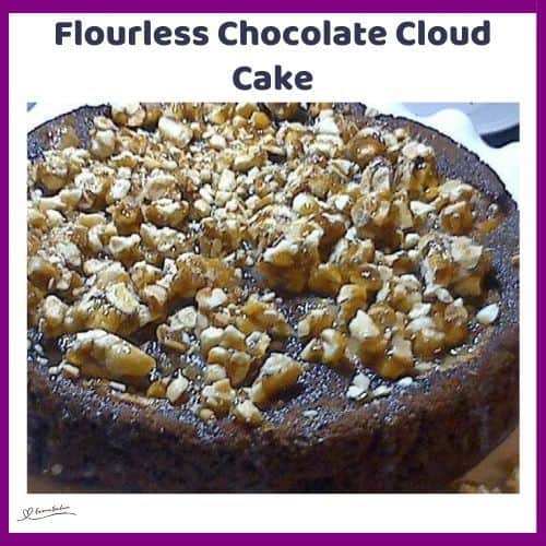 an image of a Flourless Chocolate Cloud Cake with popcorn mixed with peanut butter and chopped almonds topping