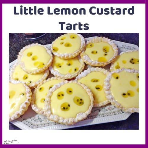 an image of Little Lemon Custard Tarts with passion fruit decoration on a white platter