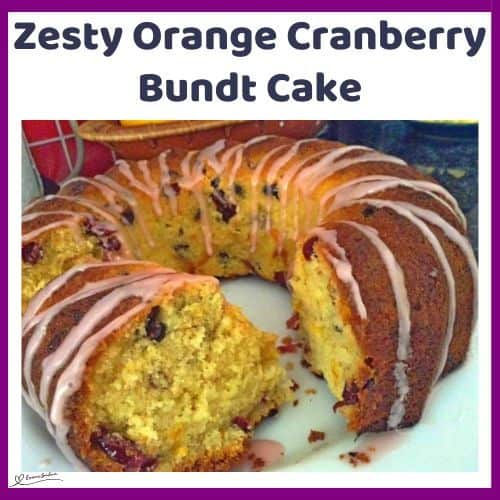 an image of a Zesty Orange Cranberry Bundt Cake on a white cake platter