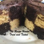 A checkered white and chocolate block cake with chocolate icing
