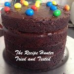 Eggless Chocolate Surprise Cake naked on the side with M&M's