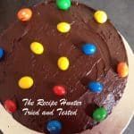Chocolate Cake seen from the top decorated with chocolate icing and some M&M's