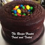 4 layer Chocolate Cake with hole in the middle filled with M&M candies