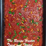 A pan filled with Vermicelli Halwa and decorated with Colored nuts
