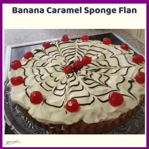 An image of a Banana Caramel Sponge Flan decorated with maraschino cherries