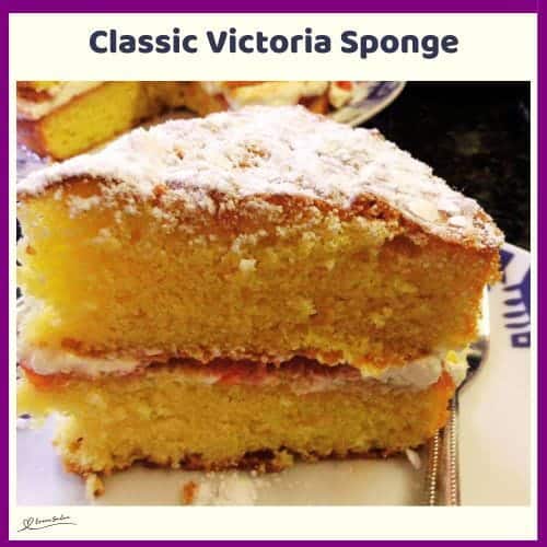 An image of a Classic Victoria Sponge with cream filling and dusted with icing sugar