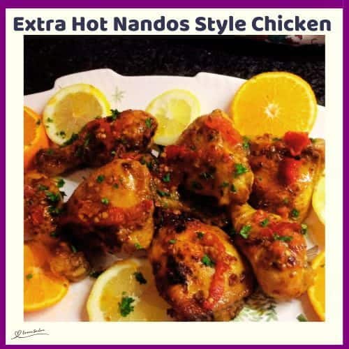 An image of a plate of Extra Hot Nandos Style Chicken with lemon slices