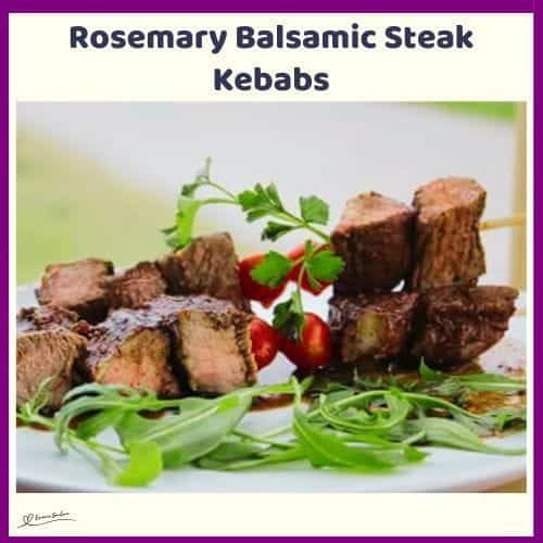 An image of Rosemary Balsamic Steak Kebabs with rocket salad on a white platter