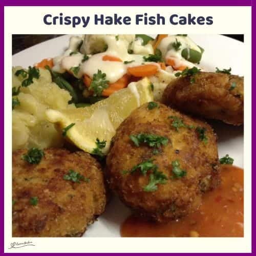 An image of Crispy Hake Fish Cakes, served with garlic and chili sauce, steamed vegetables in a white sauce