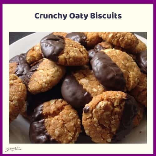 An image of Crunchy Oaty Biscuits with one corner dipped in chocolate