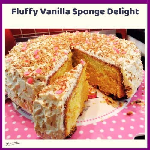 An image of a Fluffy Vanilla Sponge Cake Delight decorated with frosting and sprinkles
