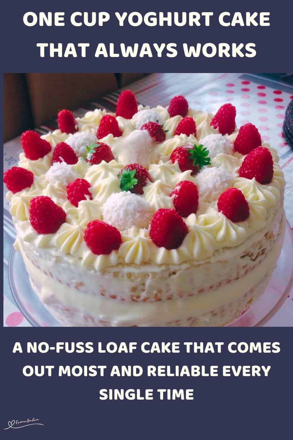 An image of a One Cup Yoghurt Cake covered with whipped cream and decorated with strawberries