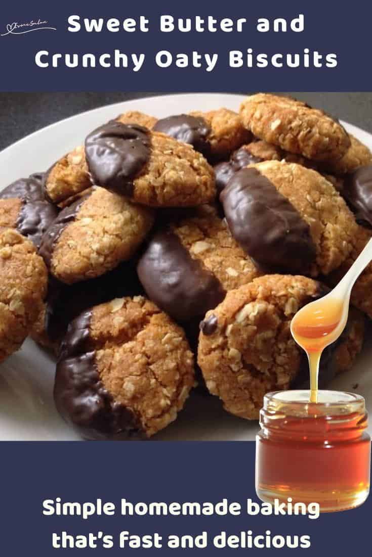 An image of Crunchy Oaty Biscuits with one corner dipped in chocolate