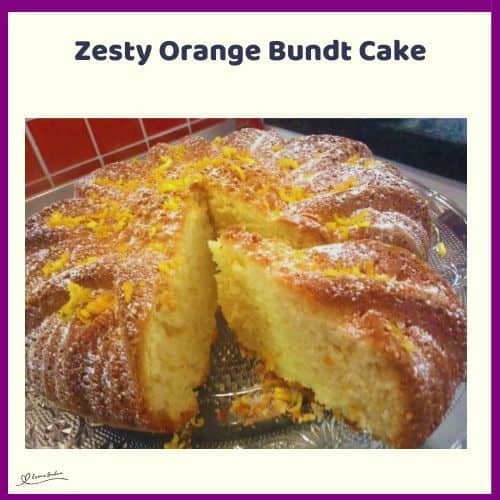 An image of a Orange Bundt Cake topped with icing sugar and orange zest