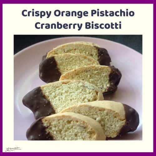 An image of slices of Crispy Orange Pistachio Cranberry Biscotti with tips dipped in chocolate