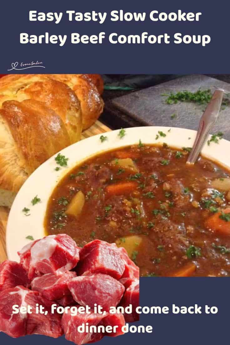 An image of a bowl of Slow Cooker Barley Beef Comfort Soup with fresh bread on the side
