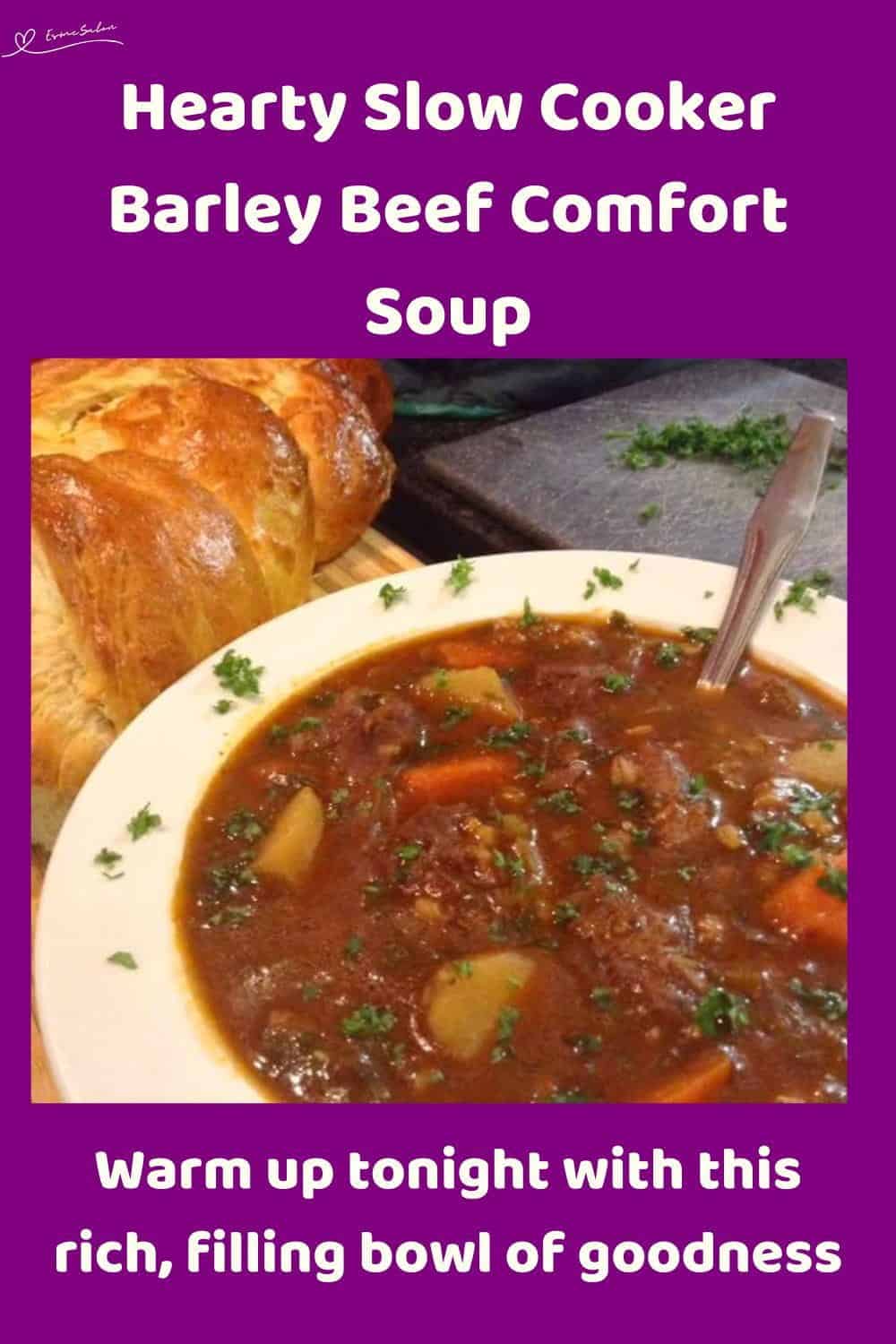 An image of a bowl of Slow Cooker Barley Beef Comfort Soup with fresh bread on the side