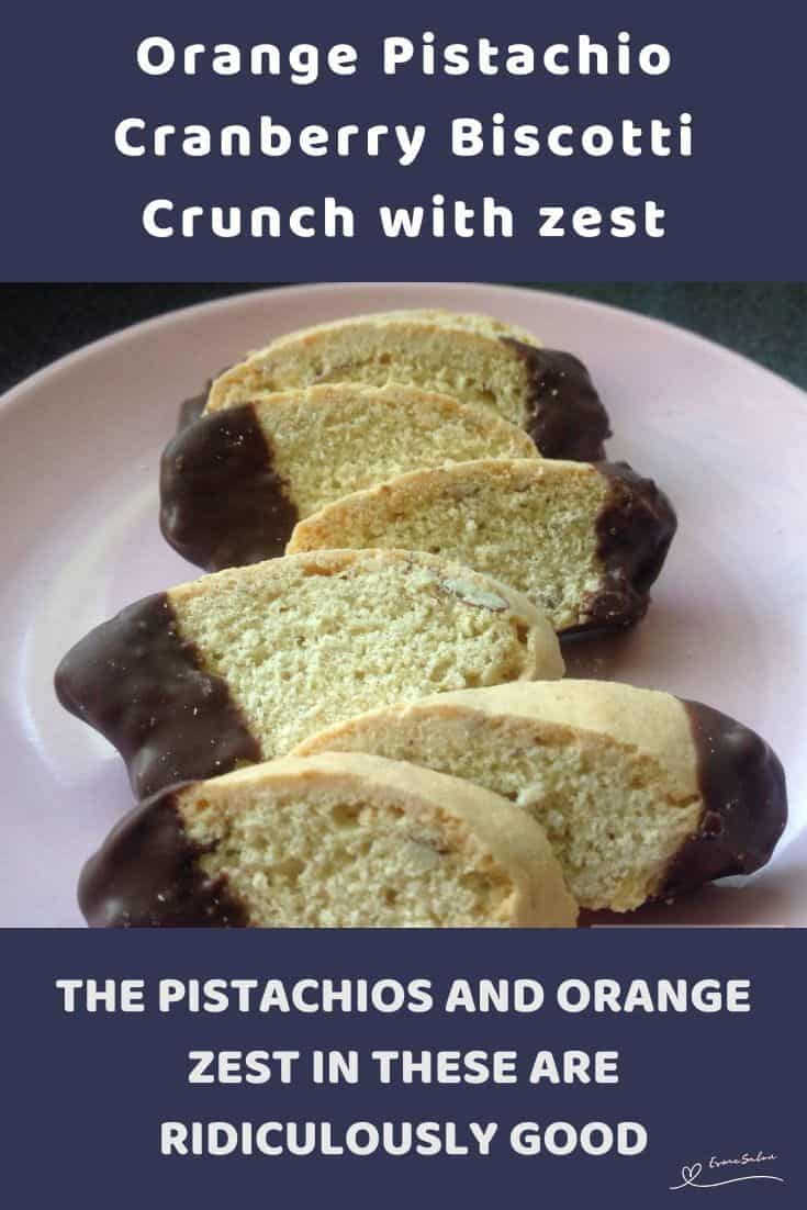 An image of slices of Crispy Orange Pistachio Cranberry Biscotti with tips dipped in chocolate