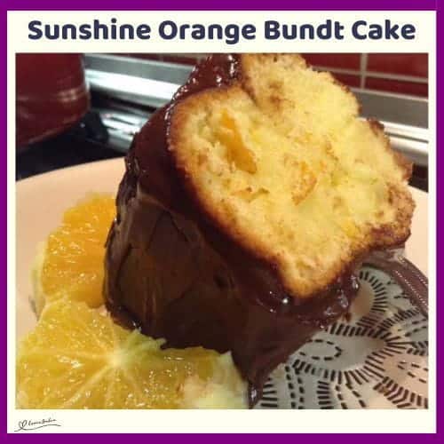 An image of a slice of Fresh Sunshine Orange Bundt with slices or orange on the side