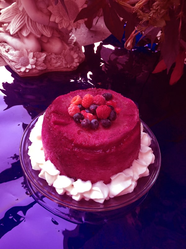 A red summer pudding with cherries on top