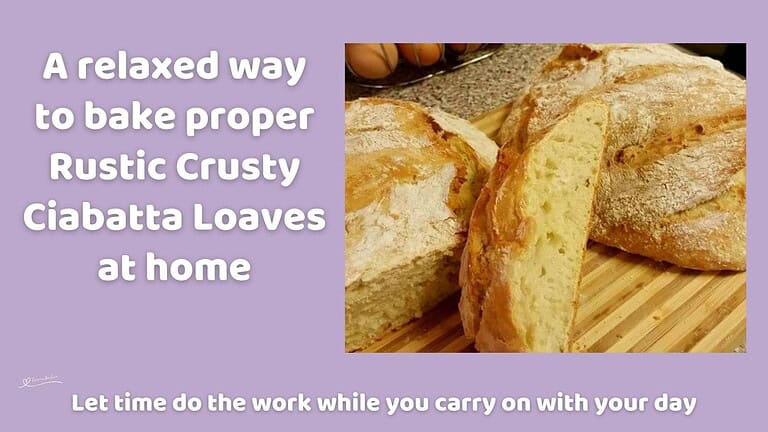 An image of 2 Rustic Crusty Ciabatta Loaves on a wooden cutting board