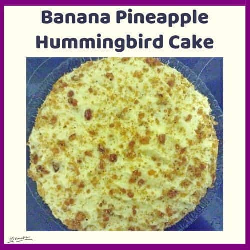 An image of a round Banana Pineapple Hummingbird Cake with pineapple, banana and pecan brittle