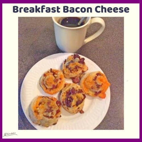 An image of 5 Breakfast Bacon Cheese Pinwheels on a white side plate with a cup of black coffee on the side