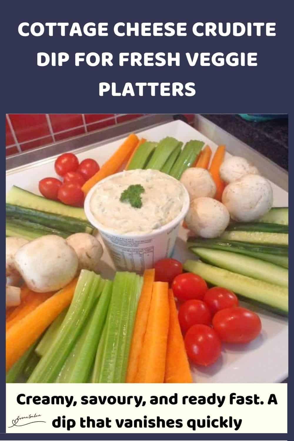 An image of a tub of Cottage Cheese Crudite Dip with fresh veggies arranged around it
