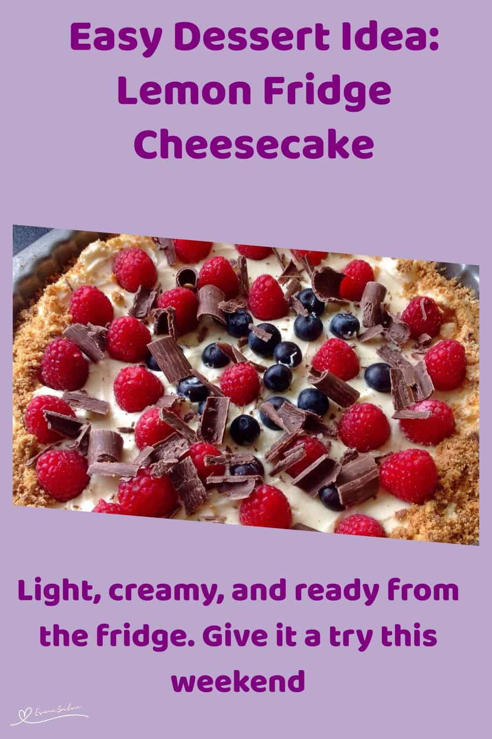 An image of a Lemon Fridge Cheesecake decorated with berries and chocolate shavings