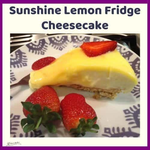 An image of a Sunshine Lemon Fridge Cheesecake decorated with fresh strawberries