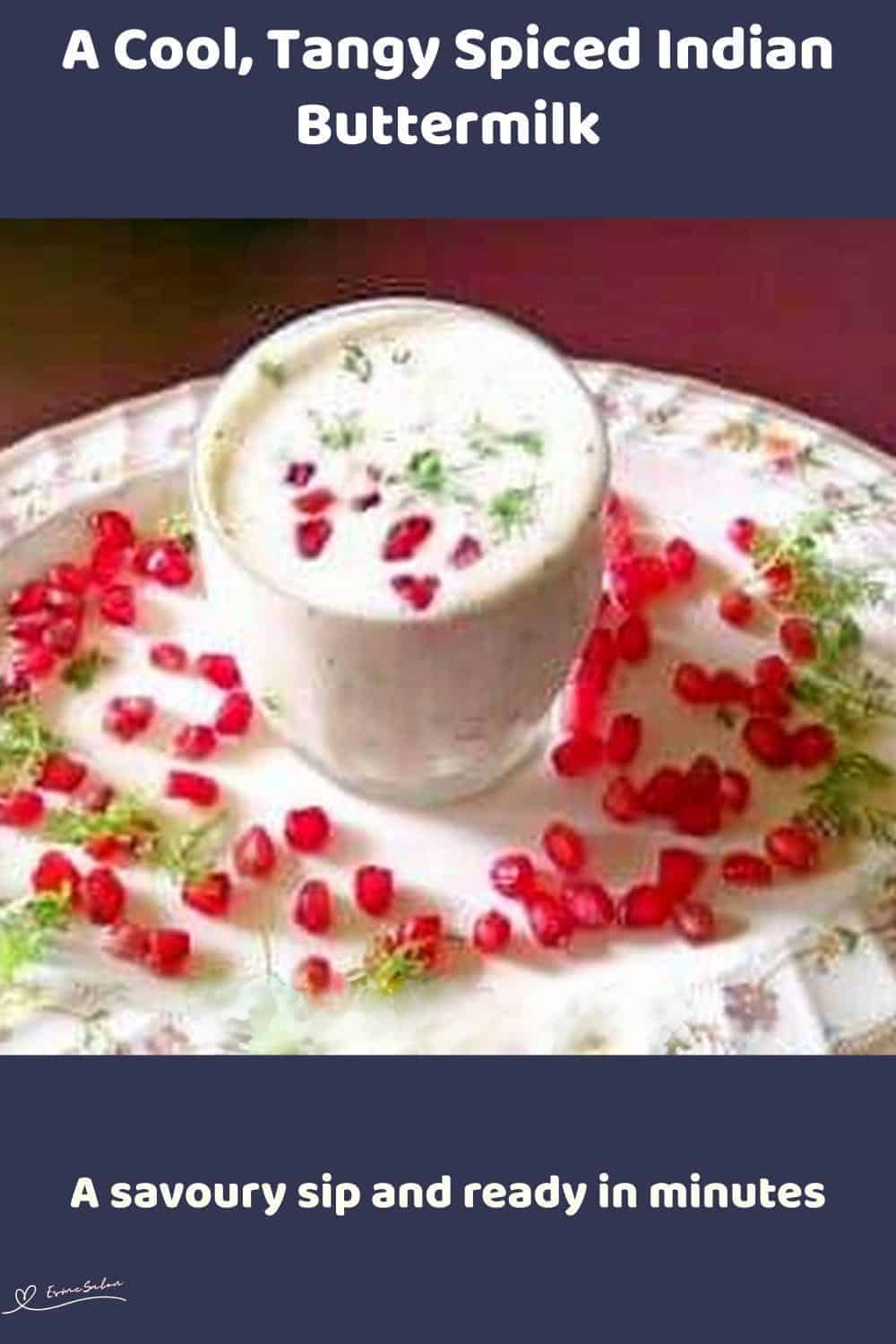 An image of a glass with Spiced Indian Buttermilk and garnishes with fresh coriander leaves, pomegranate seeds
