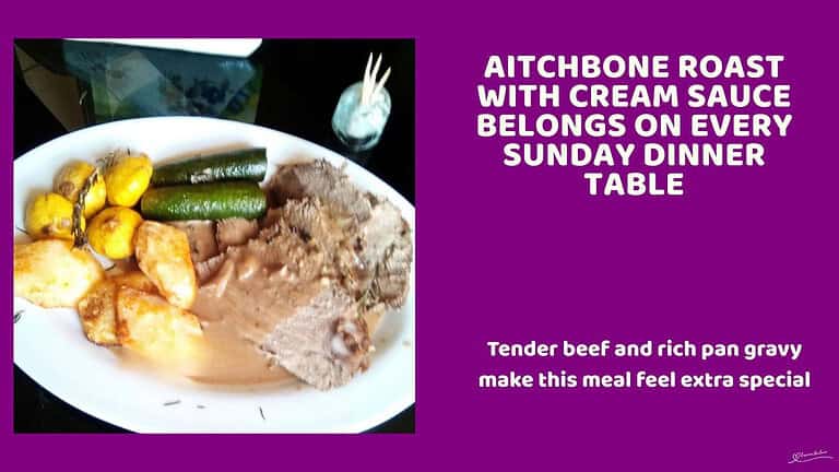 An image of a white dinner plate filled with Aitchbone Roast with Cream Sauce, with crispy potatoes and veggies on the side